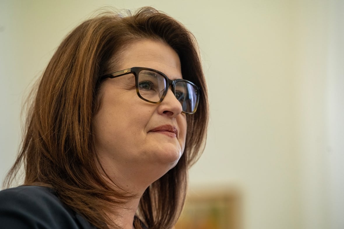 A woman with glasses is shown.