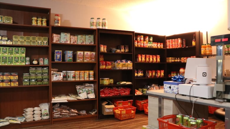 Shelves of dry goods and a cash register.