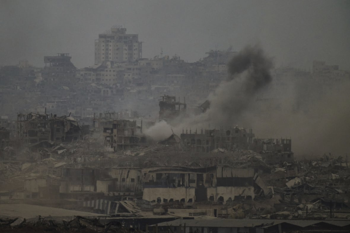 The smoke rises in the destroyed houses after smoke.