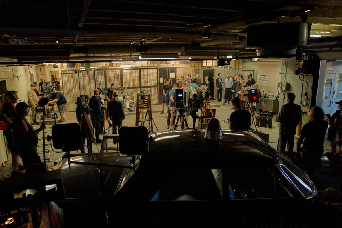 A group of people from people inside a dark room. 