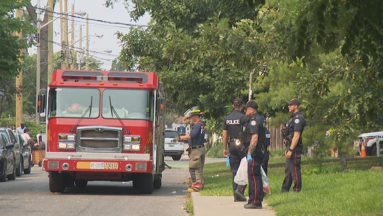 Photo showing firefighters and police in a park