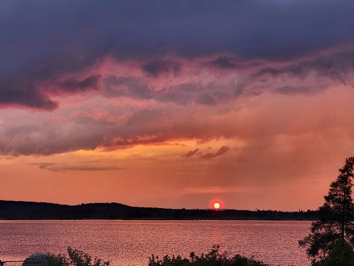 Purple pink and orange sky over pond