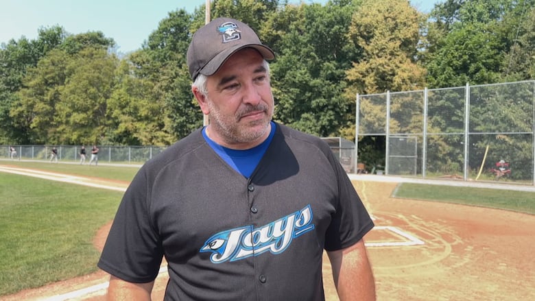 A man in a black baseball cap and Charlottetown Jays jersey.