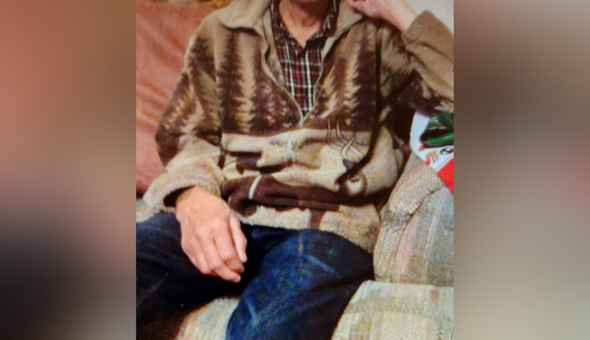 A person is sat on a chair with a sweater