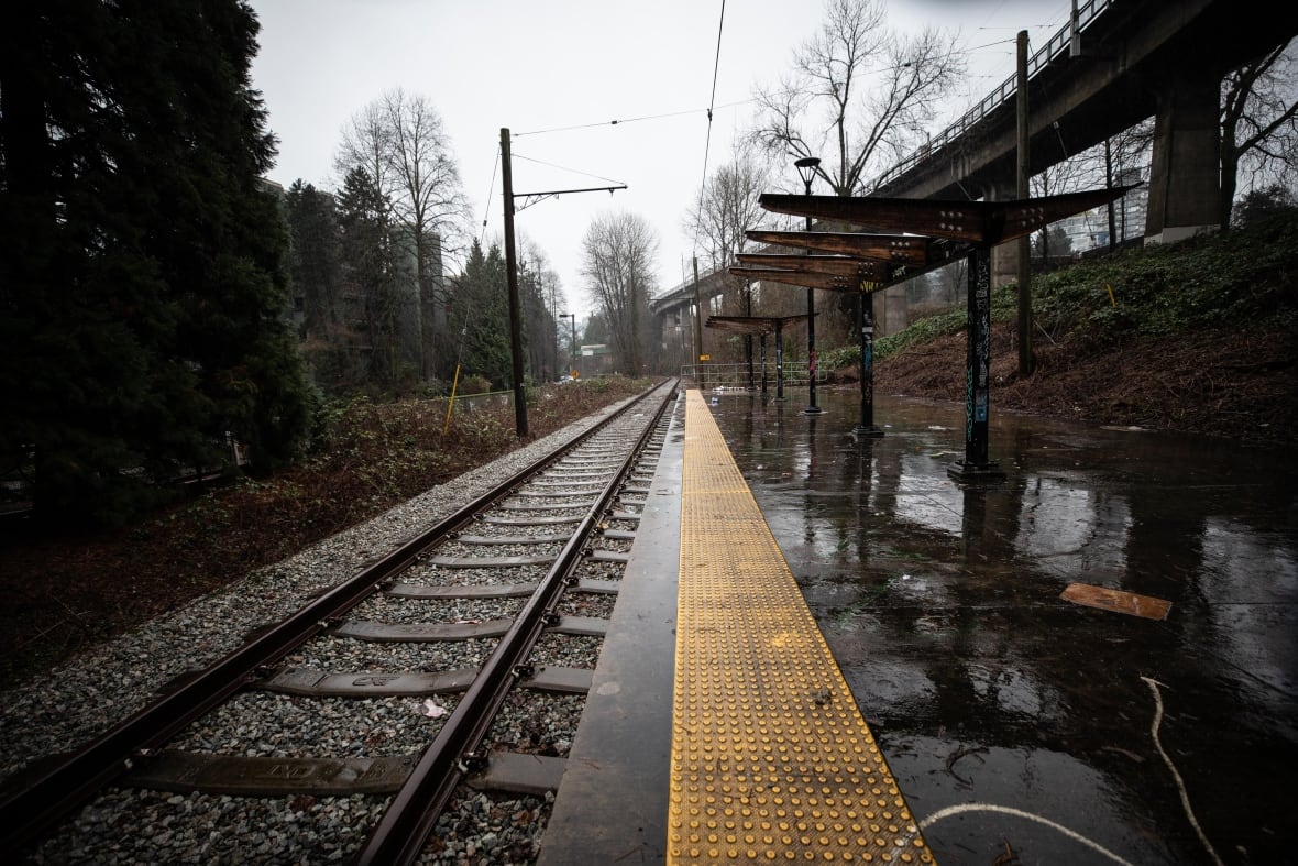 A disused railway track is seen on a rainy day.