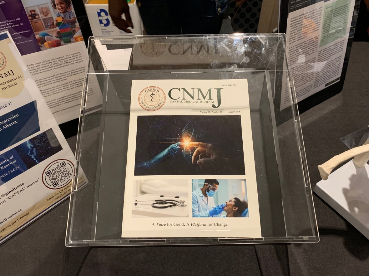 A medical magazine sits in a display box on a table with infographics
