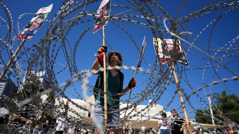 Protesters hold up signs during a protest.