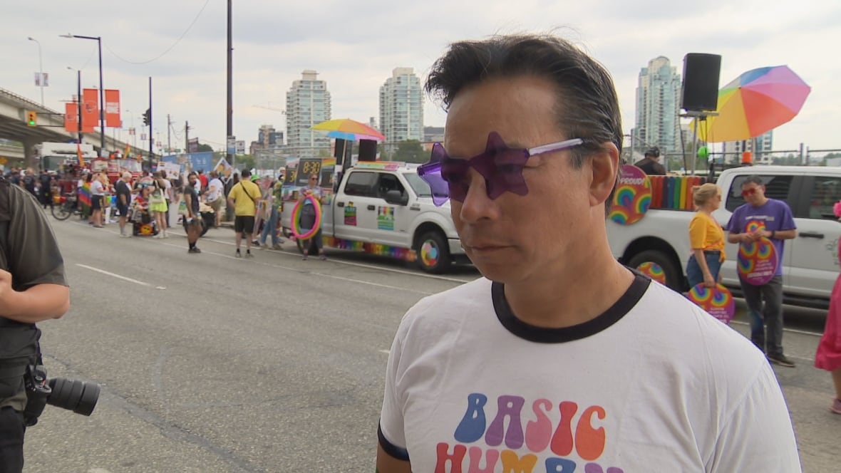 Vancouver Mayor Ken Sim attends the city's annual Pride Parade, wearing star-shaped purple sunglasses and a 'Basic Human Decency' T-shirt. 