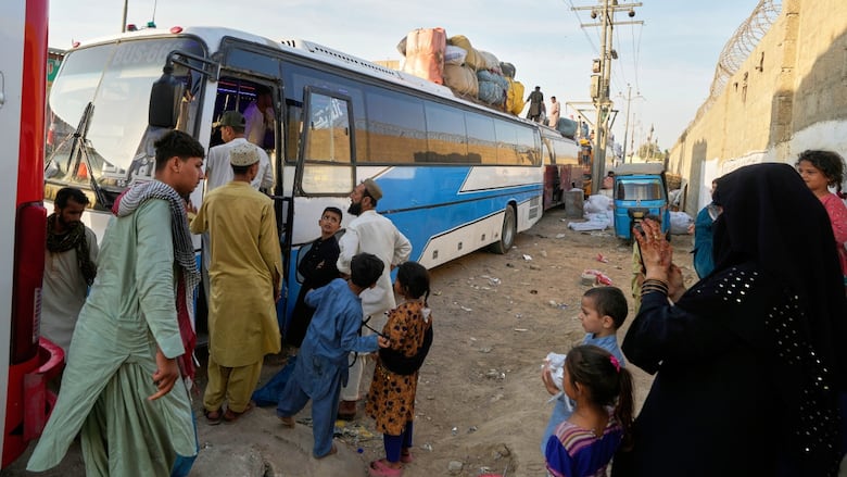 Afghan refugees board a bus to leave for their homeland Afghanistan.