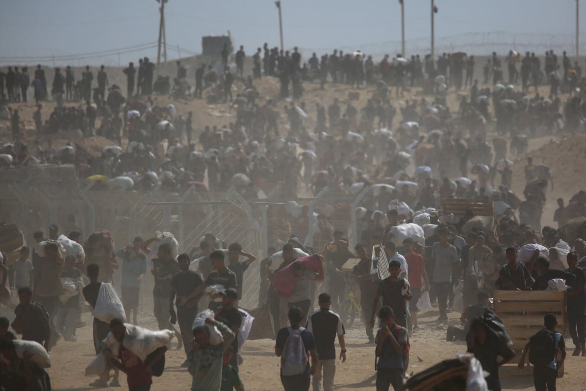 Palestinians carry aid supplies in Gaza.