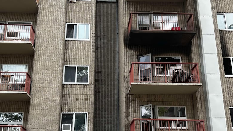 Apartment balconies with black smoke around one unit