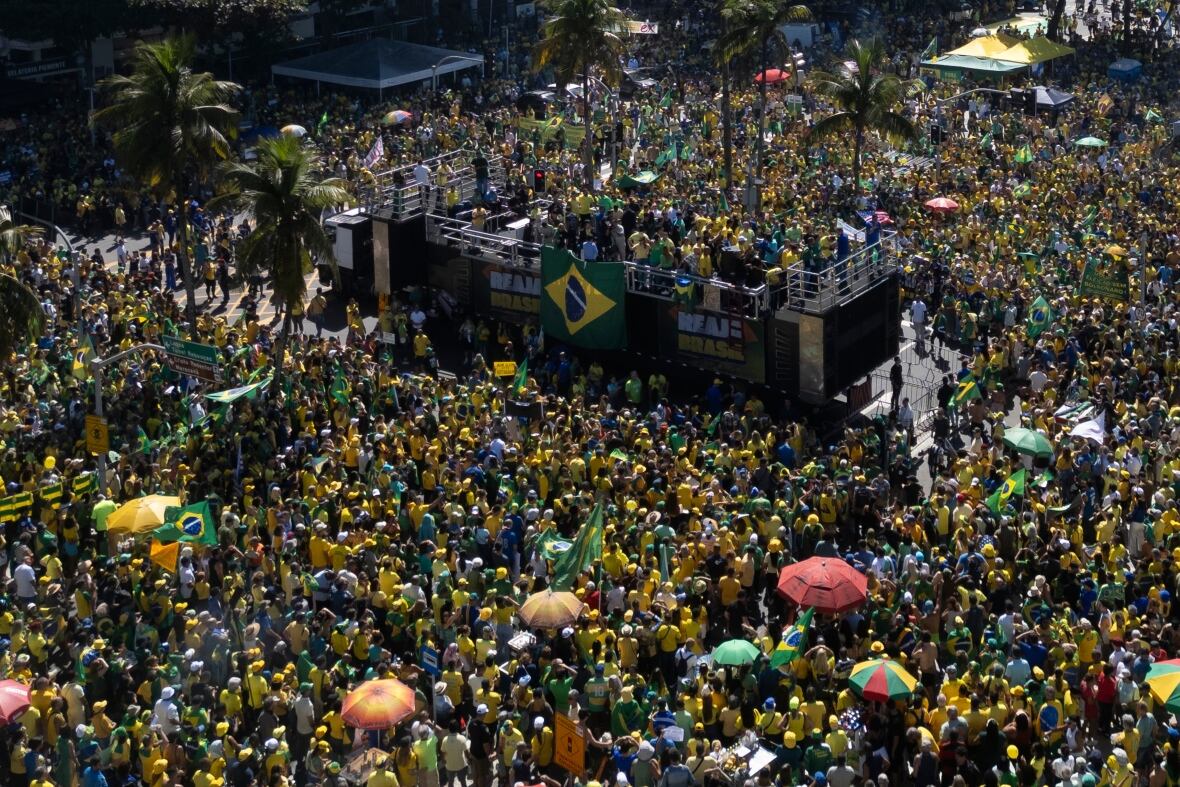 A large crowd gathers at a meeting.