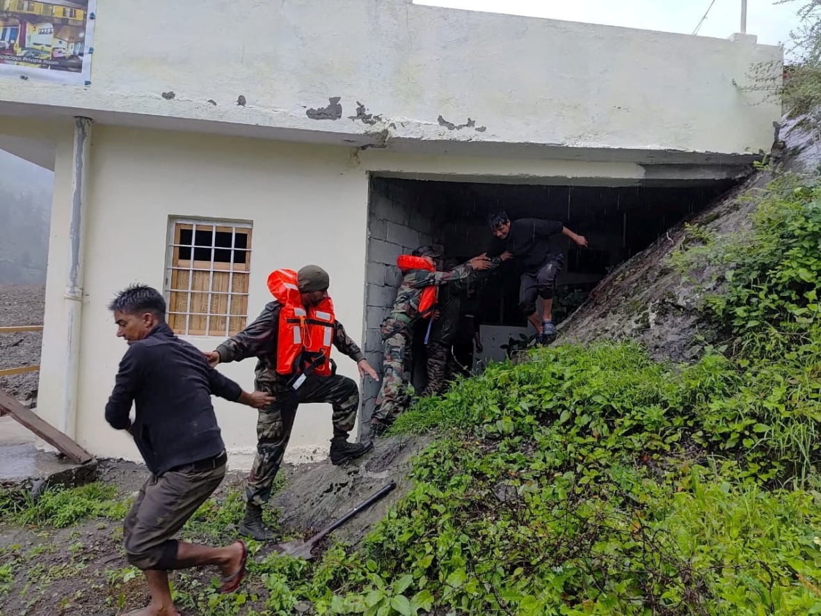 Rescuers help people during a flashing flood.