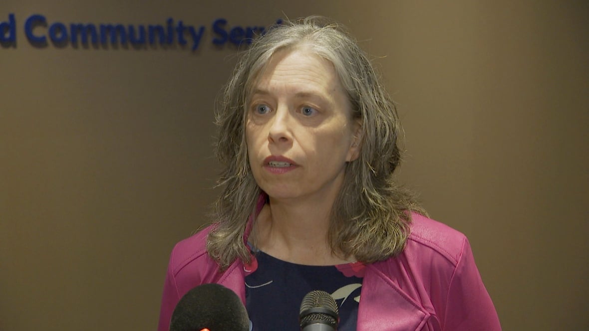 Woman with long grey hair talking