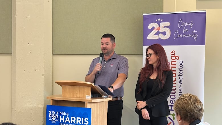 Two people stand at a podium.
