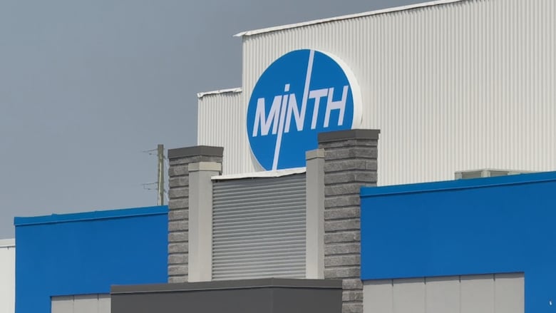 A blue and white building with the Minth logo 