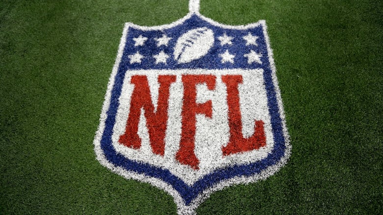 The NFL logo is seen at the 50-yard line.