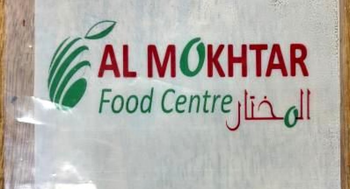 Une étiquette alimentaire sur laquelle on peut lire en lettres rouges : Al Mokhtar Food Centre