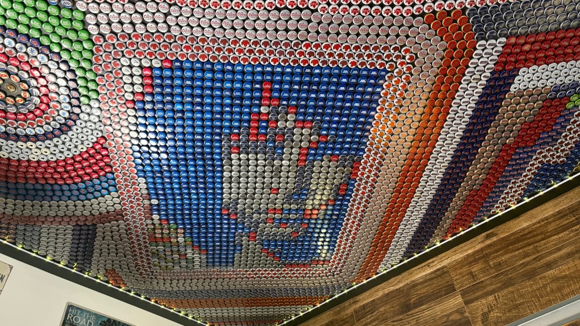 A garage ceiling mural made up of beer caps features a portrait of Doors frontman, Jim Morrison.