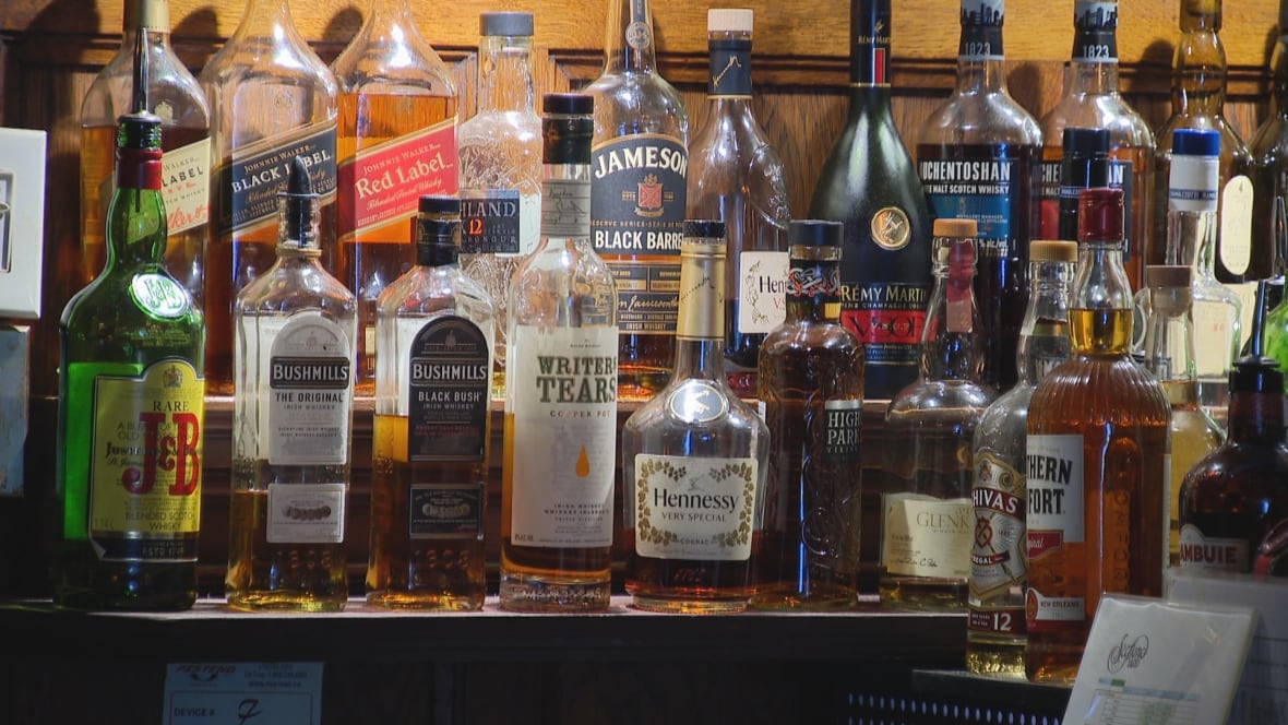 Alcohol bottles lit from behind in a Toronto bar. 
