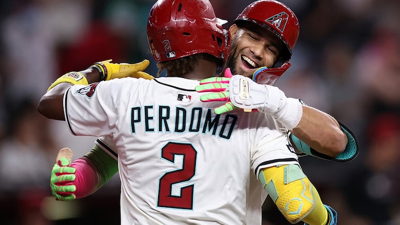 Arizona Diamondbacks outfielder Lourdes Gurriel Jr. celebrates with teammate Geraldo Perdomo after hitting a two-run home run during the eighth inning against the visiting San Diego Padres at Chase Field on August 5, 2025 in Phoenix.