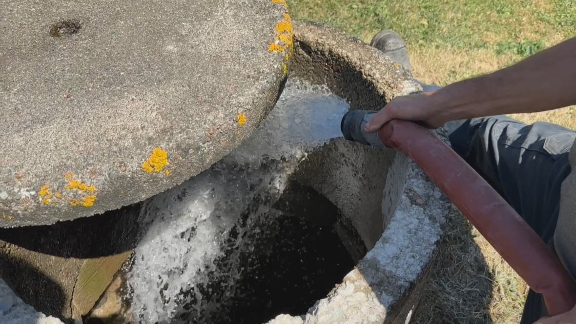Hose fills stonewalled well with water