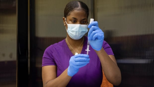 A vaccinator draws a coronavirus disease (COVID-19) vaccine in Philadelphia in May 2021.