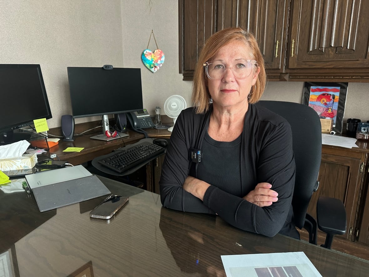 Shelley sitting at her desk in her office. 