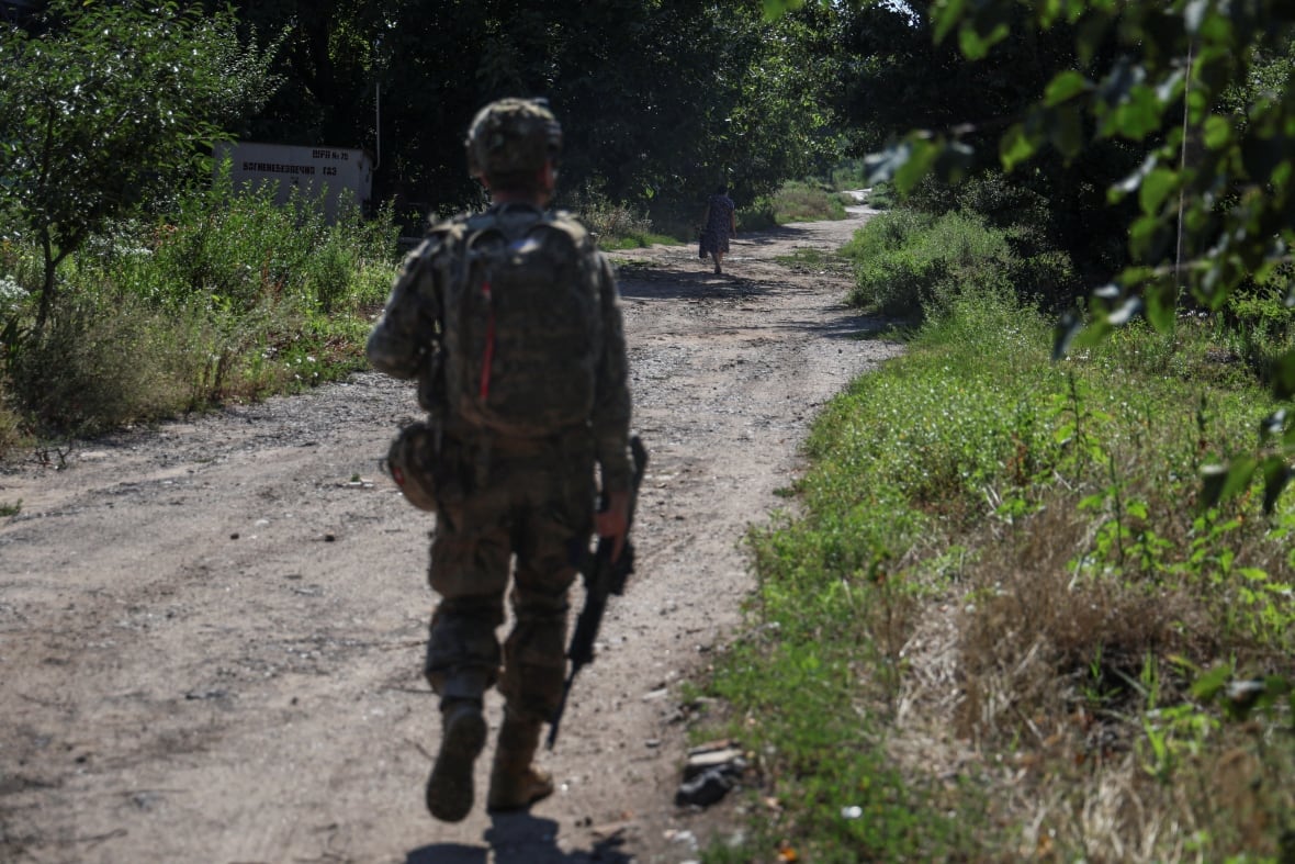 A Ukrainian soldiers walking along a street in the frontline town of Kostiantynivka, Ukraine, in August 2025.