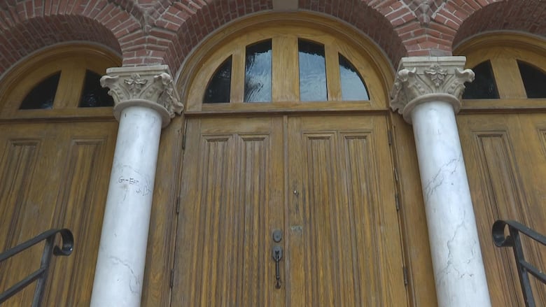 Several pairs of large exterior double doors are closed shut.