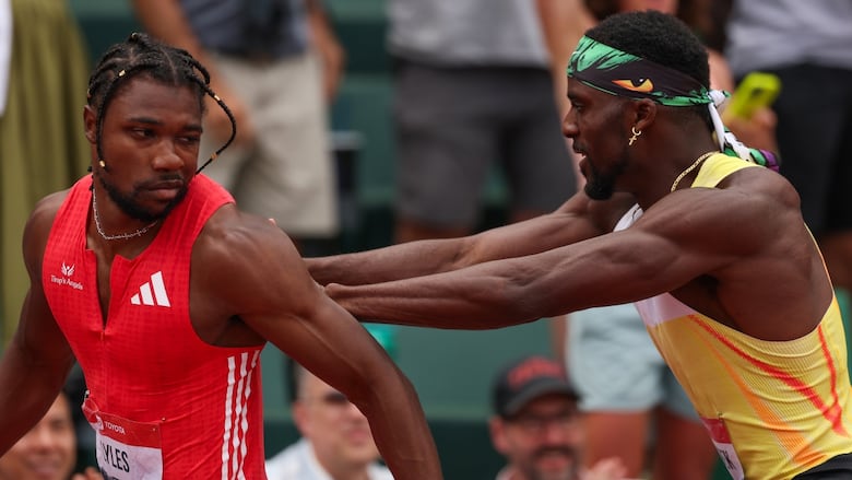 A runner shoves another runner.