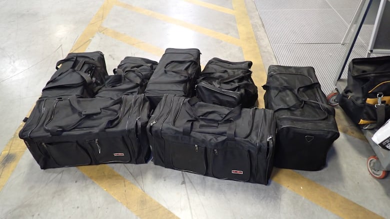 black duffle bags on the floor