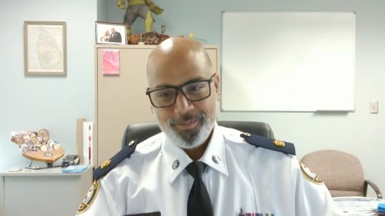 A man is wearing a white police uniform.