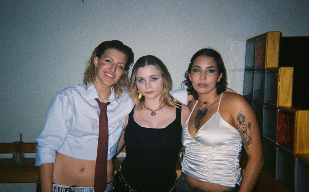 Three people posing for a photo. 