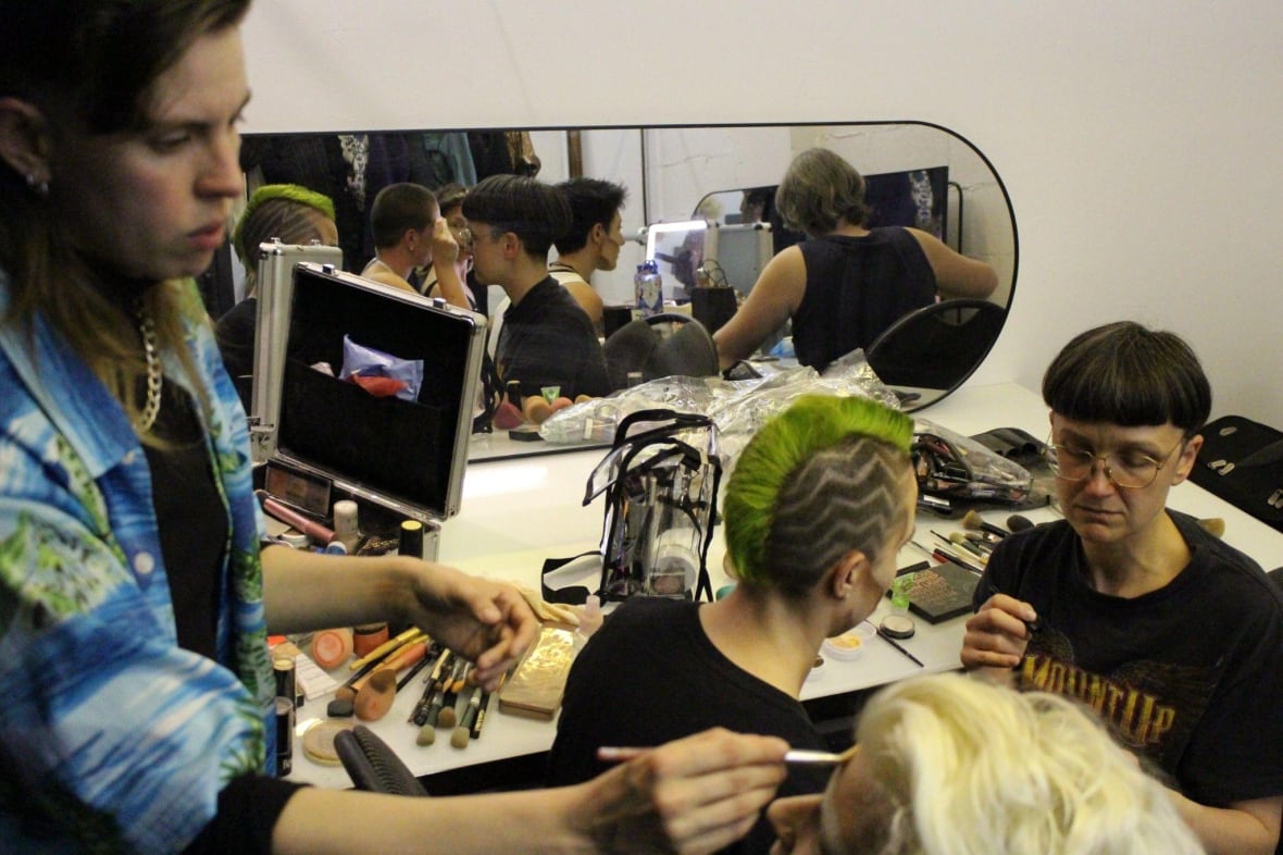 People getting their makeup done. 