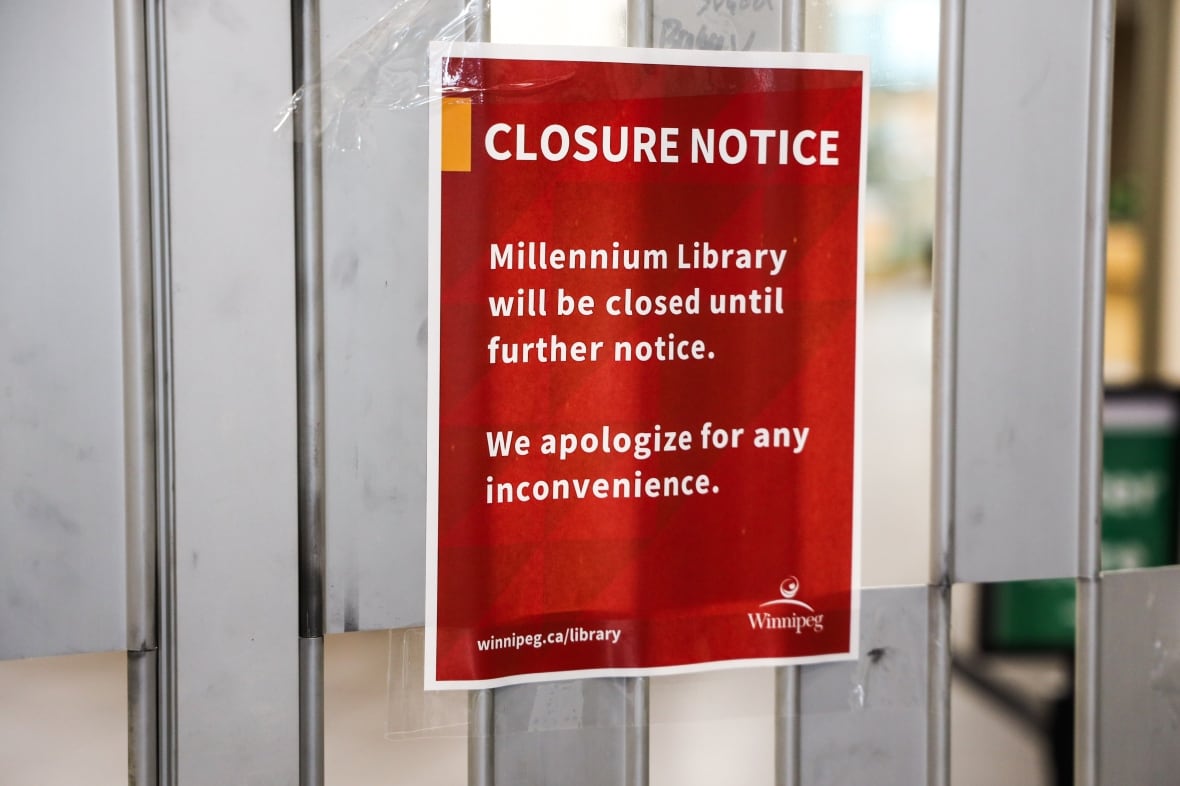 A red sign says that the Millennium Library is closed until further notice. 