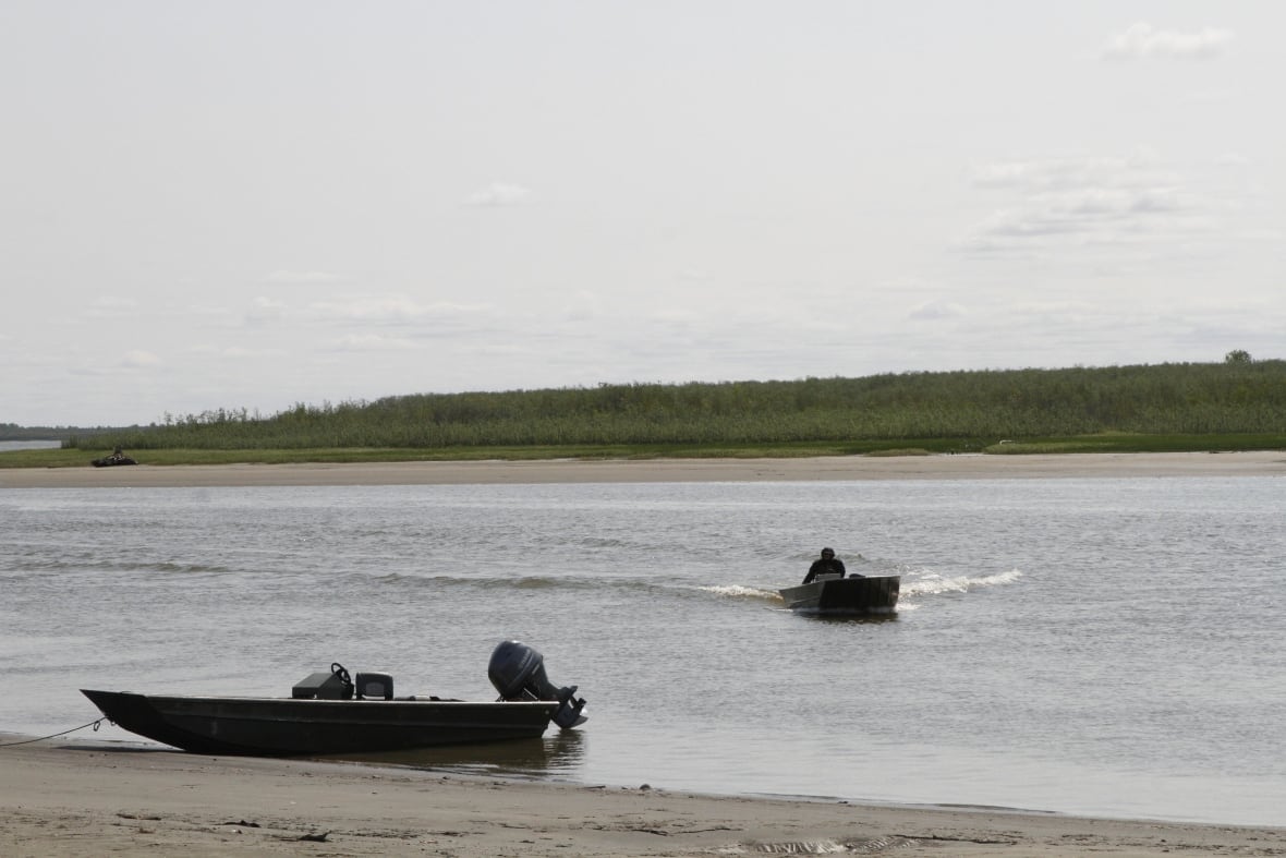 Small motor boats on a river.