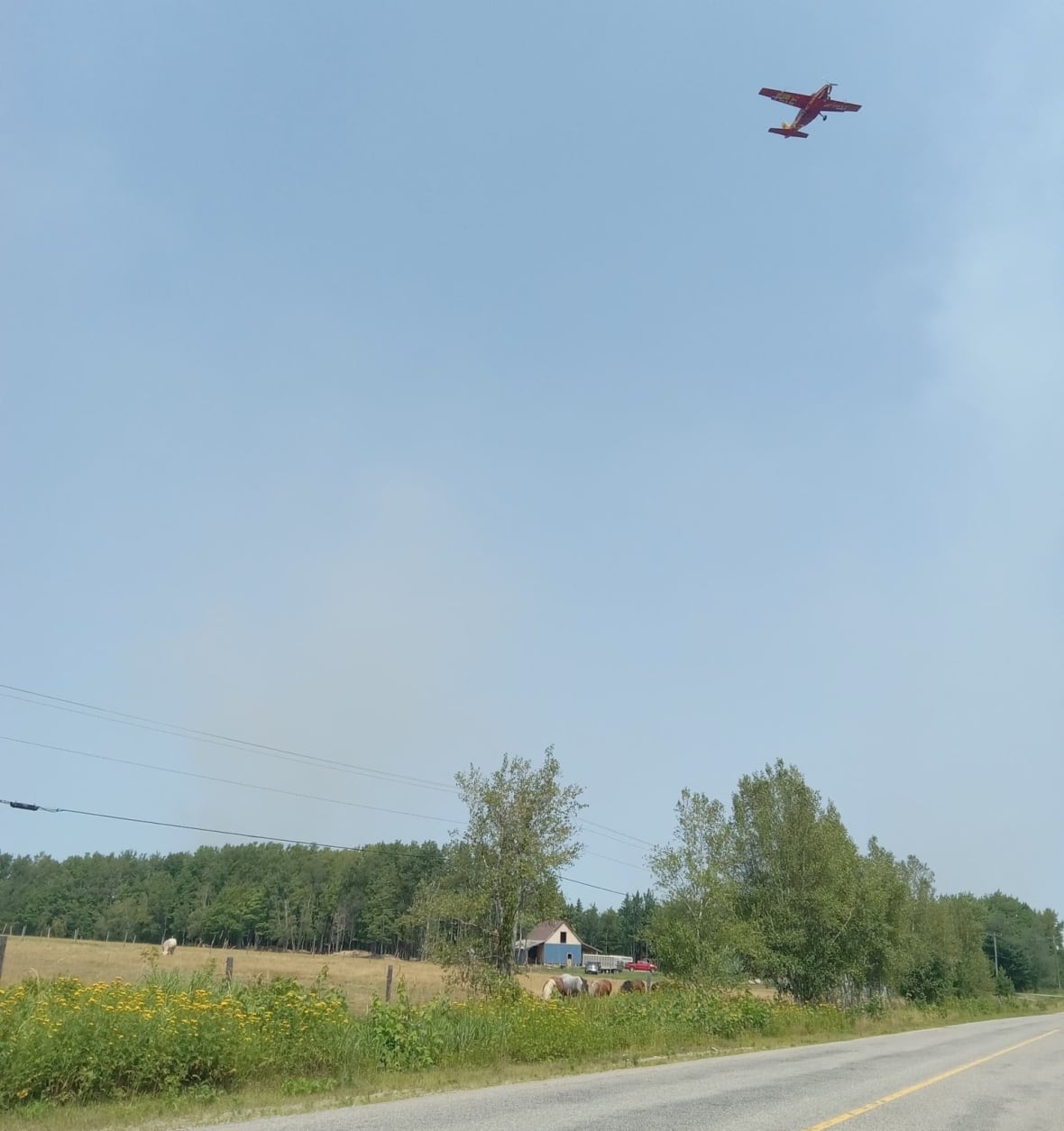 shot of smokey sky and water bomber 
