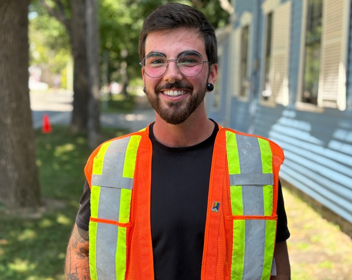 A man with an orange vest.