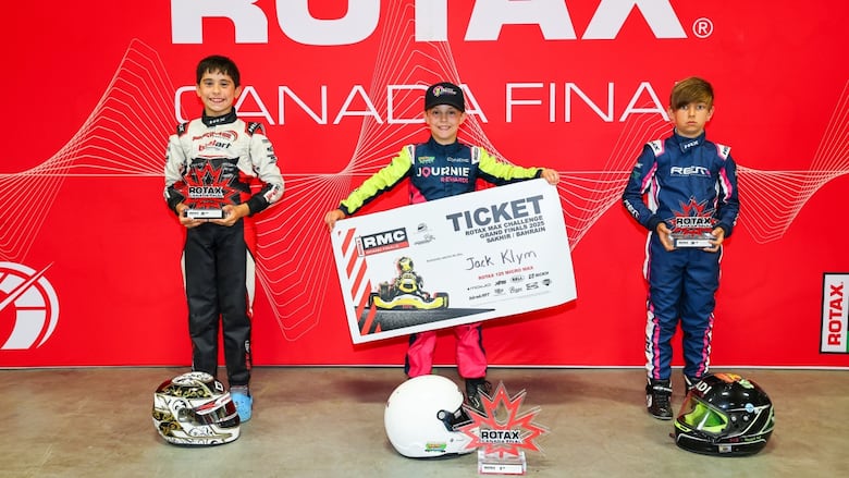 Jack Klym holds up his ticket to bahrain.