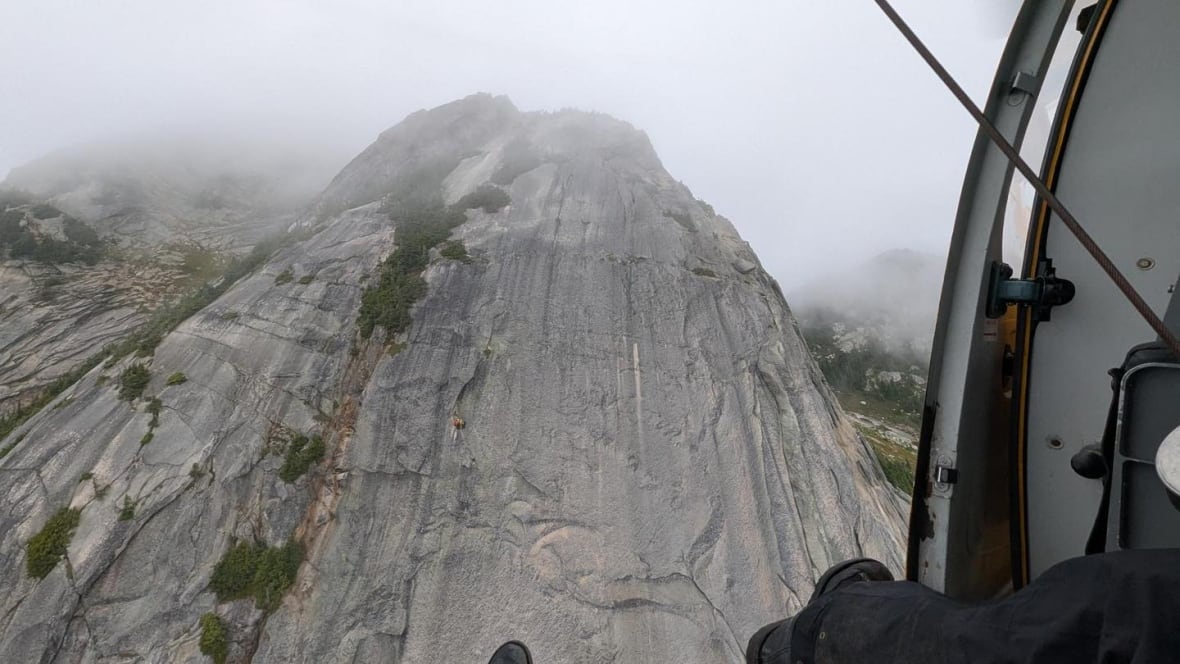 A rescue helicopter approaches Yak Peak near Hope, B.C., where two climbers were stranded partway up the sheer face.