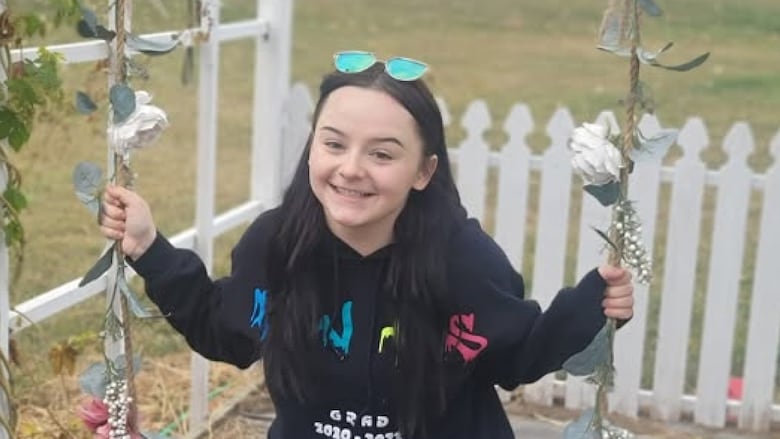 Smiling teenage girl on a swing