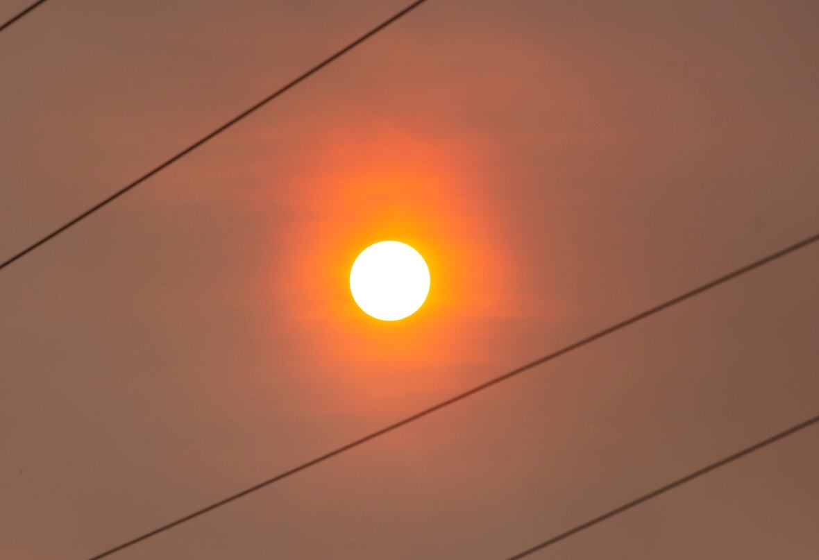An orange sun in a smoky sky.