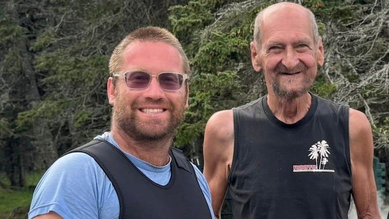 Two men smiling