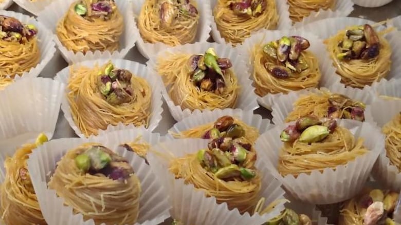 Rows of pistachio baklava in muffin liners. 