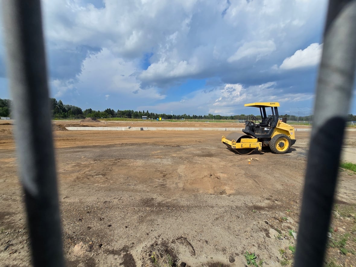 Construction equipment on a dirt field.