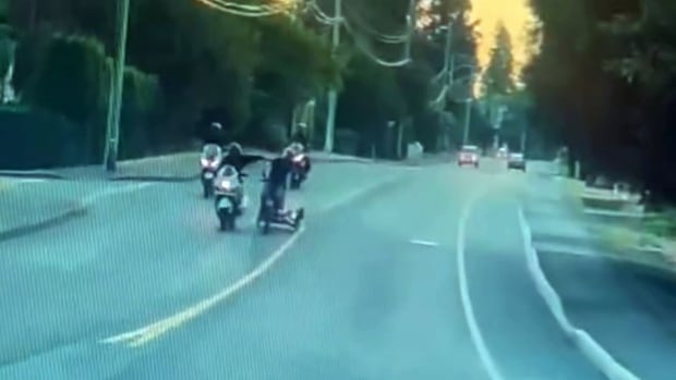 Dash cam still shows the moment a motorcyclist reaches toward a 78-year-old cyclist in Nanaimo, sending the cyclist into oncoming traffic.