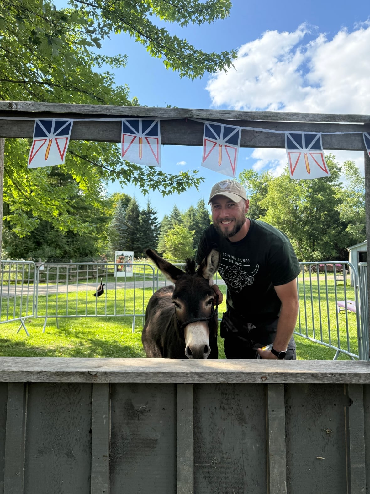 Hank the miniature donkey and barnyard bachelor poses with farm manager Tyler Garrard at Erin Hill Acres in Erin, Ont., in this undated handout photo. THE CANADIAN PRESS/Handout - Tyler Garrard (Mandatory Credit)