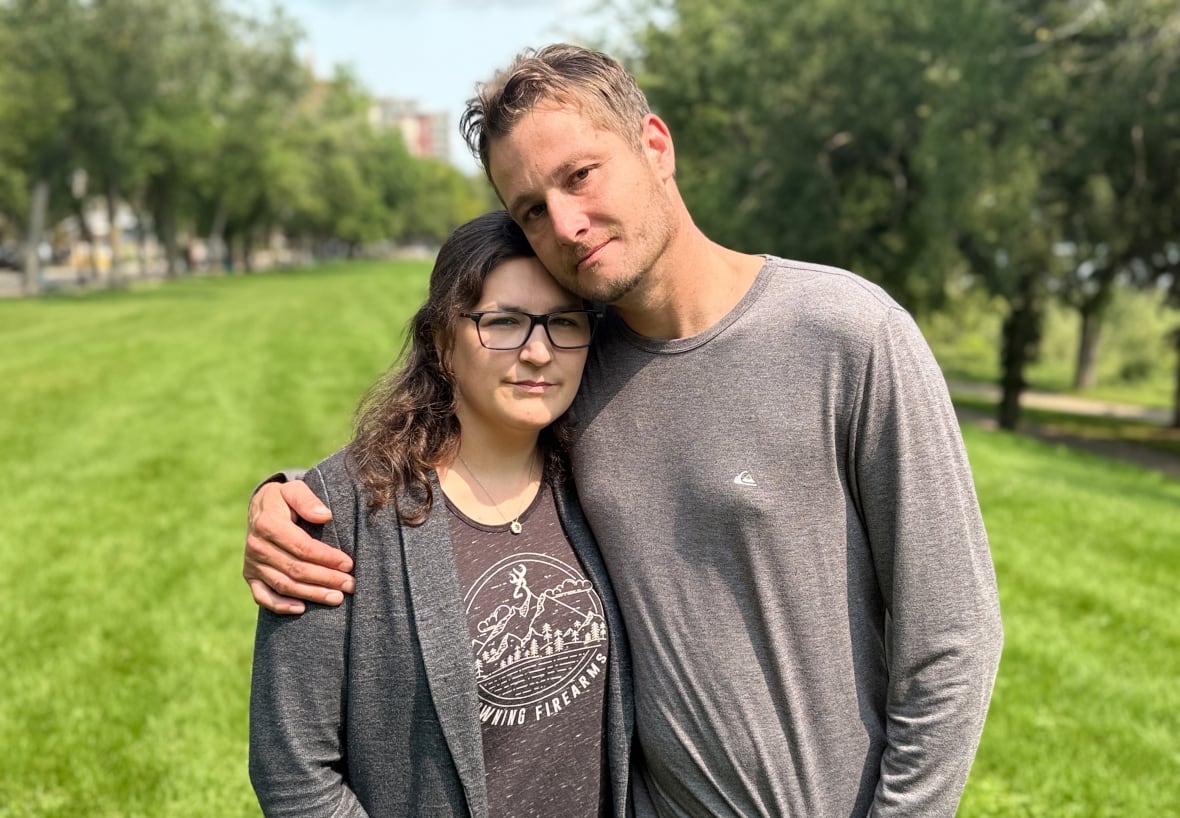Dustin Trumbley and his fiancé, Joanne Churchill stand in a field
