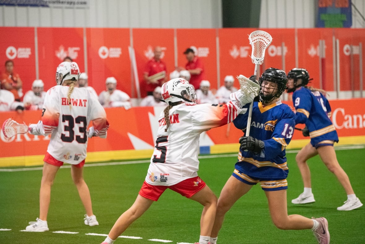Two women's box lacrosse players collide during a match.